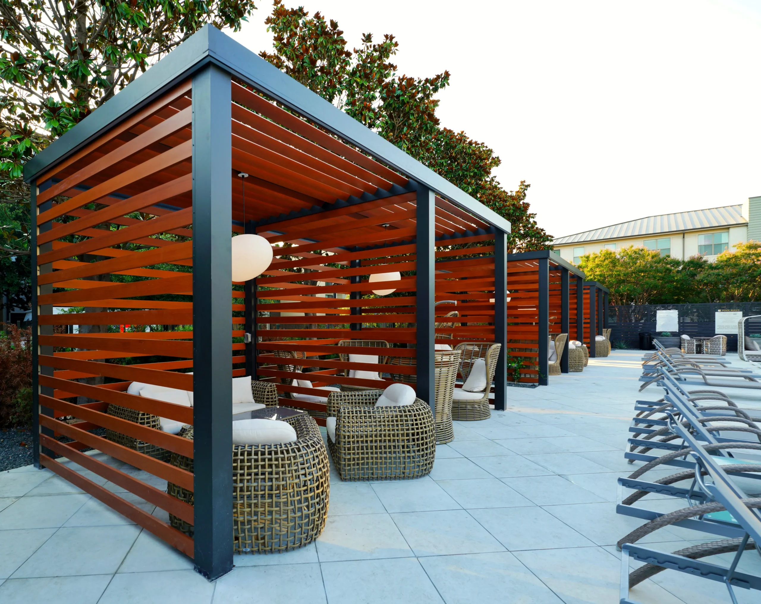 Warm-toned wood-slat cabana for hospitality lounges